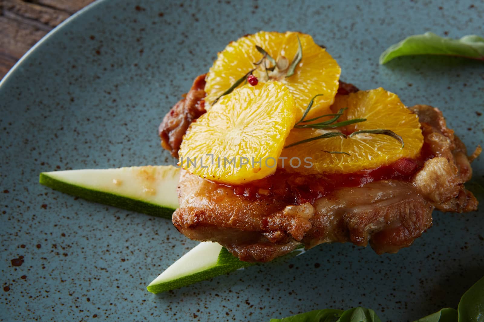 Chicken Steak with oranges and greens. Shallow dof