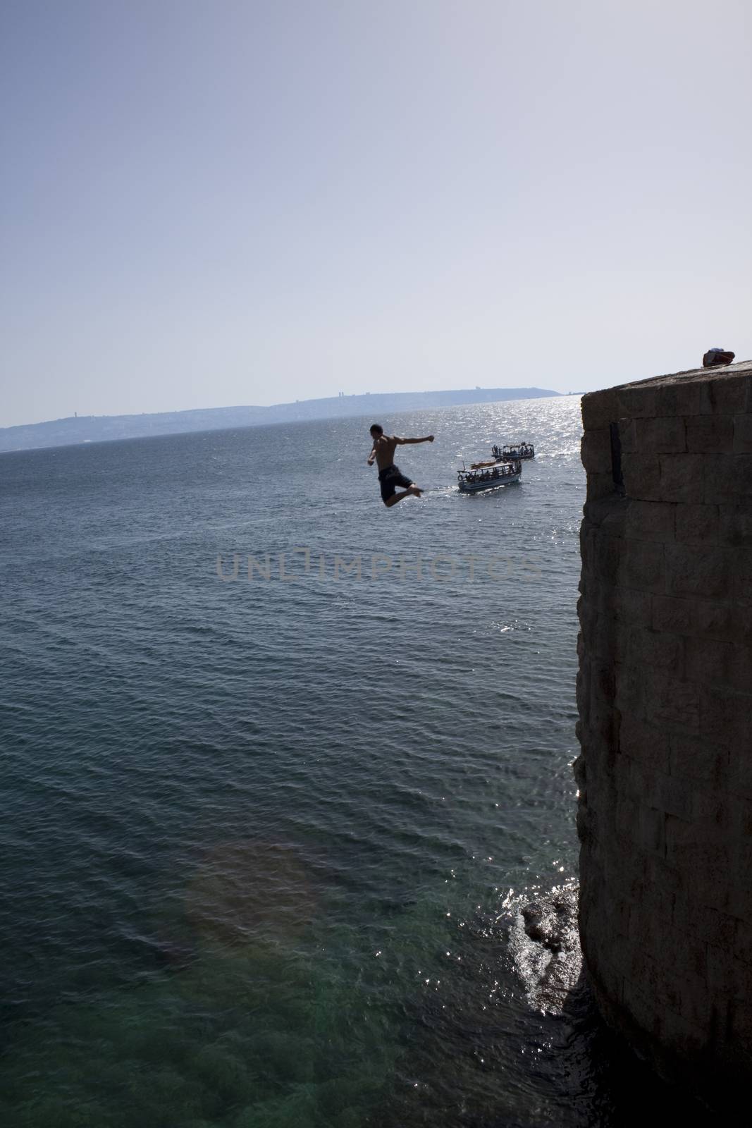 man jumping to see from a citadel  wall