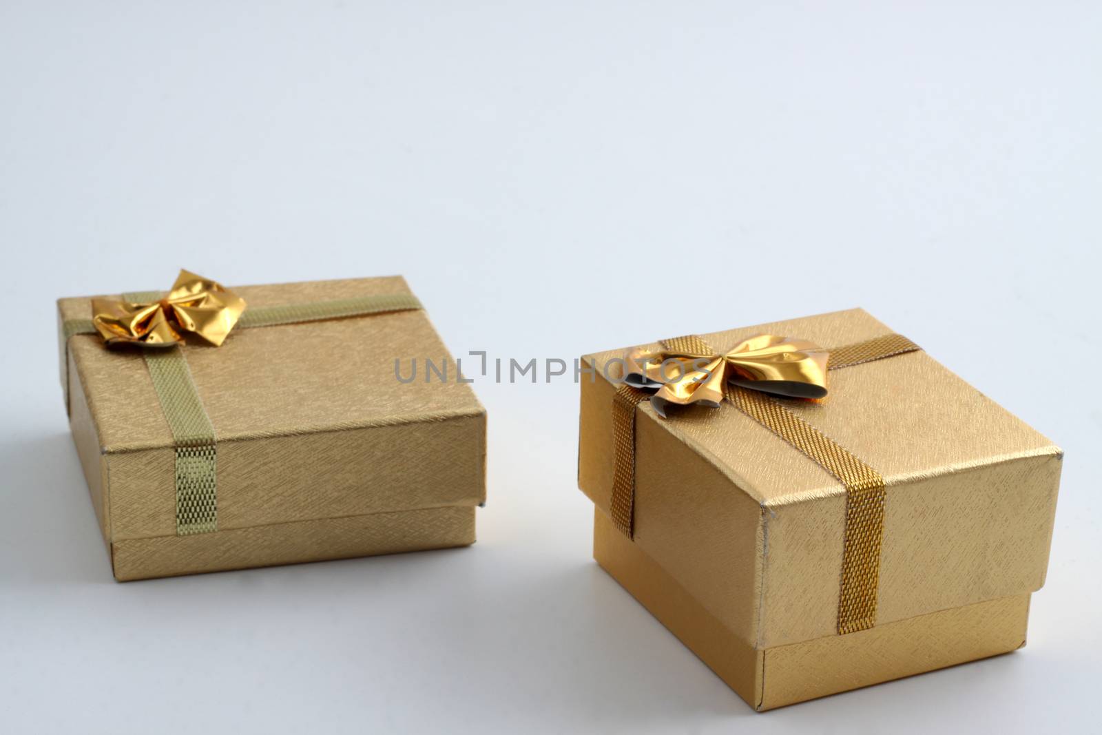  two gold  pattern gift ring box with golden ribbon