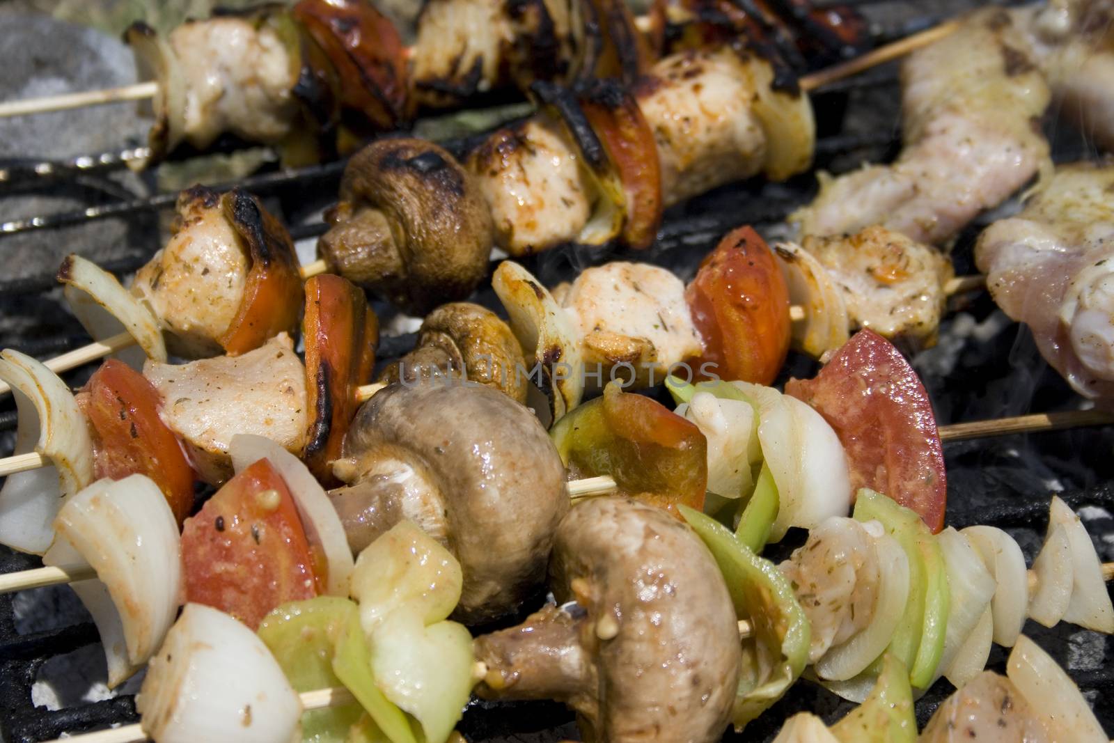 meat ,vegetables and mushrooms on a grill