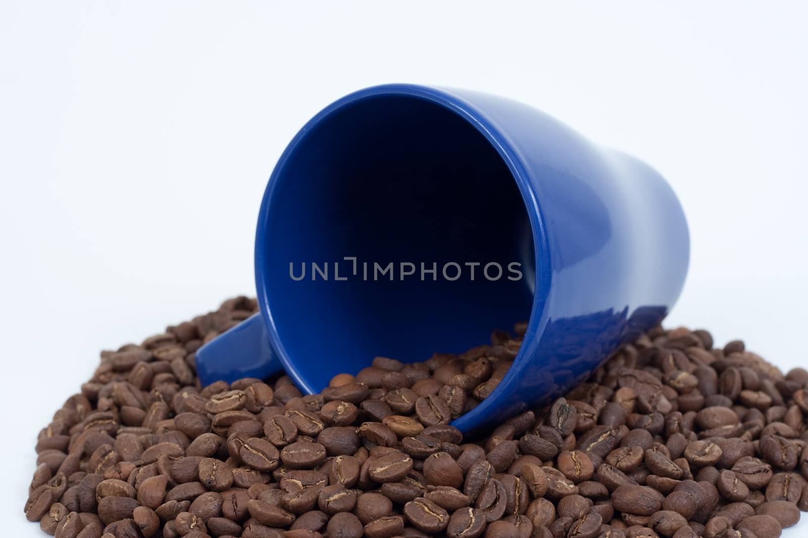 Blue mug in coffee beand isolated on white background
