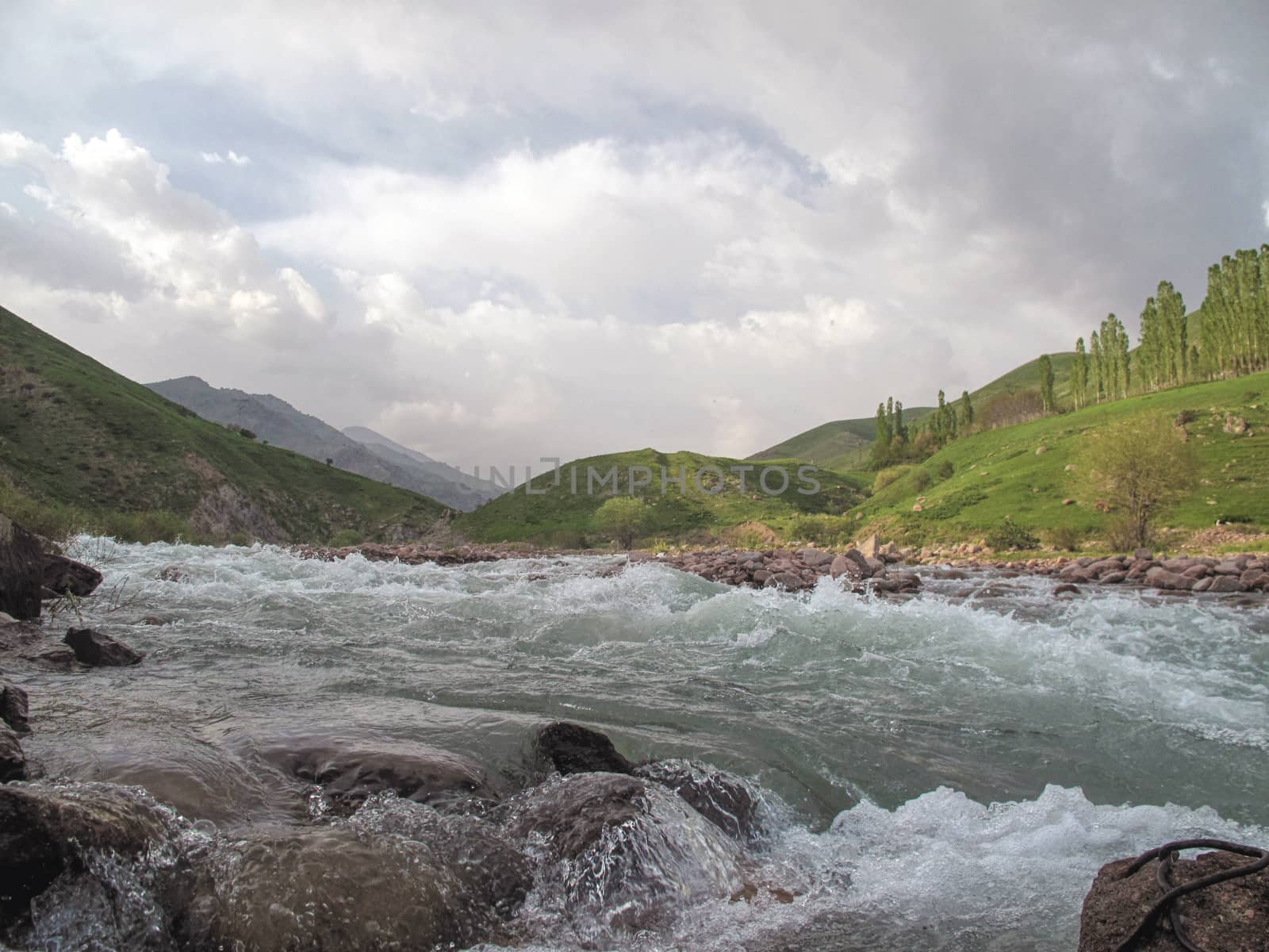  mountain river with hills and trees in the distance