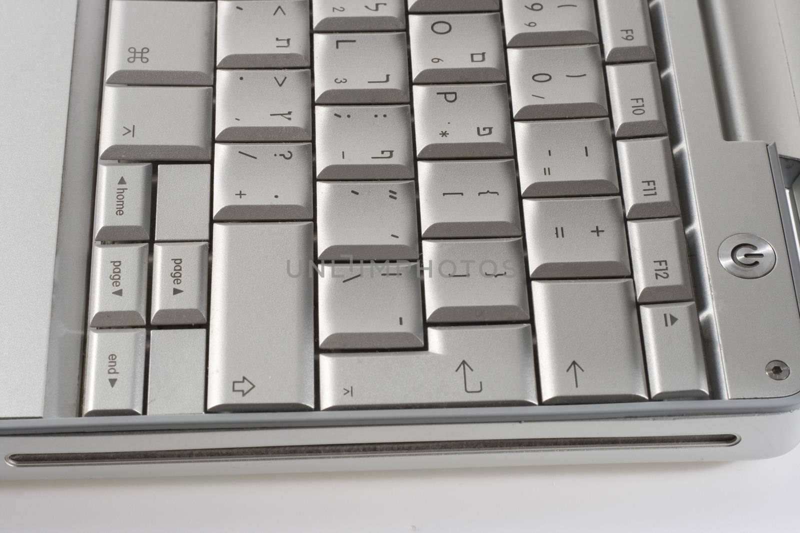 silver laptop keyboard with hebrew latters