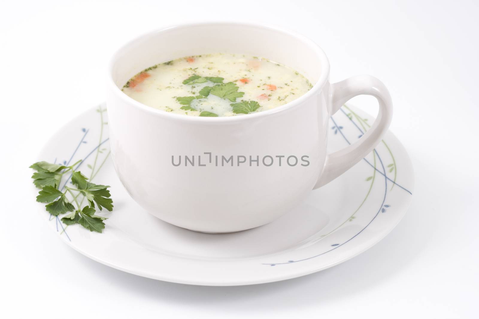 bowl with soup on a plate with parsley