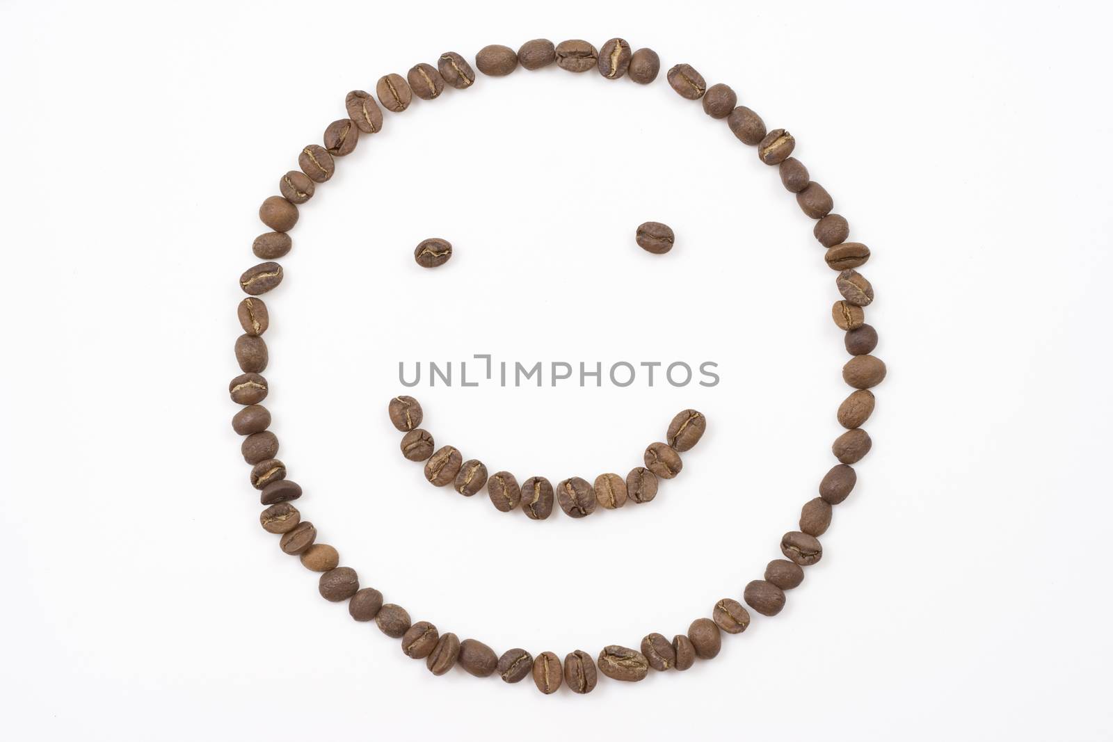 smiley face made out of coffee beans on white background