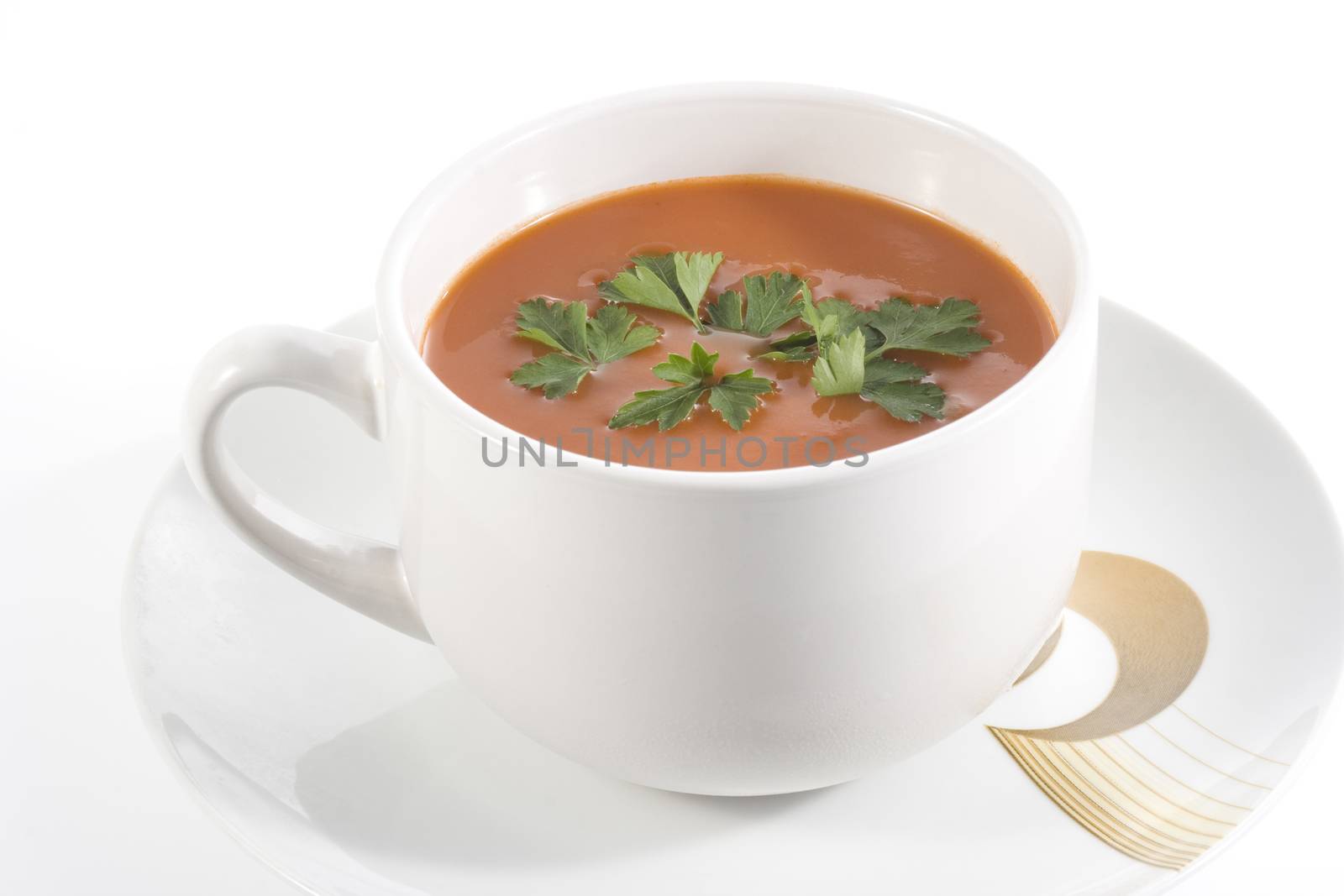 tomato soup with parsley on wwhite background