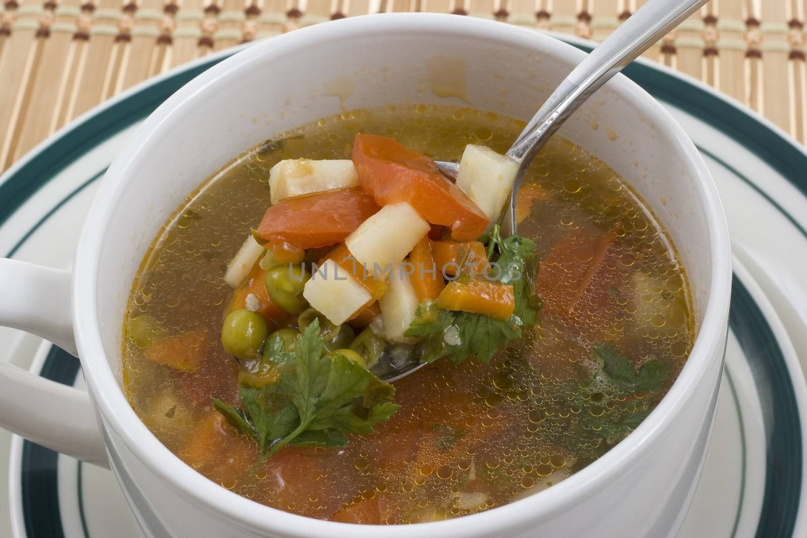 vegetable soup tasting with a spoon