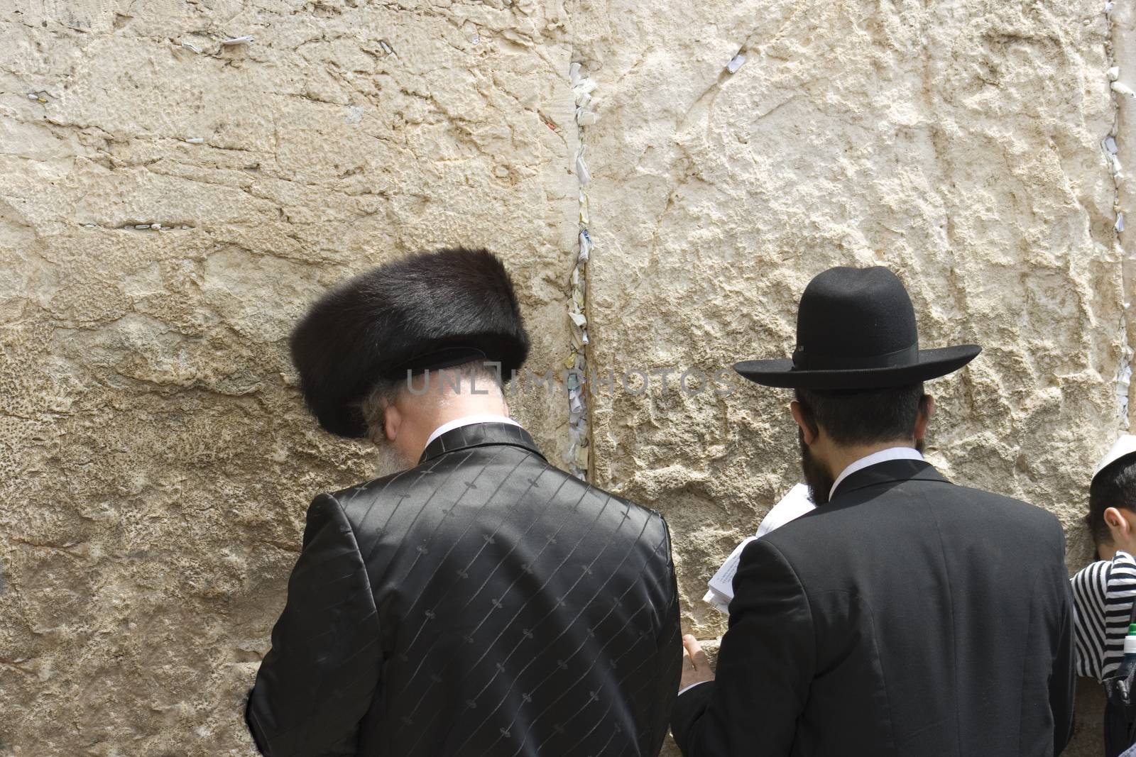 two men pray at the west wall in jerusalem