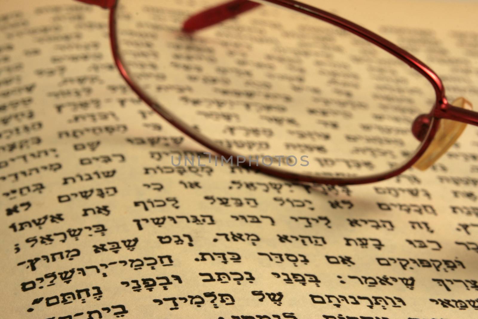 old testament in hebrew old yellow page with a pair of glases