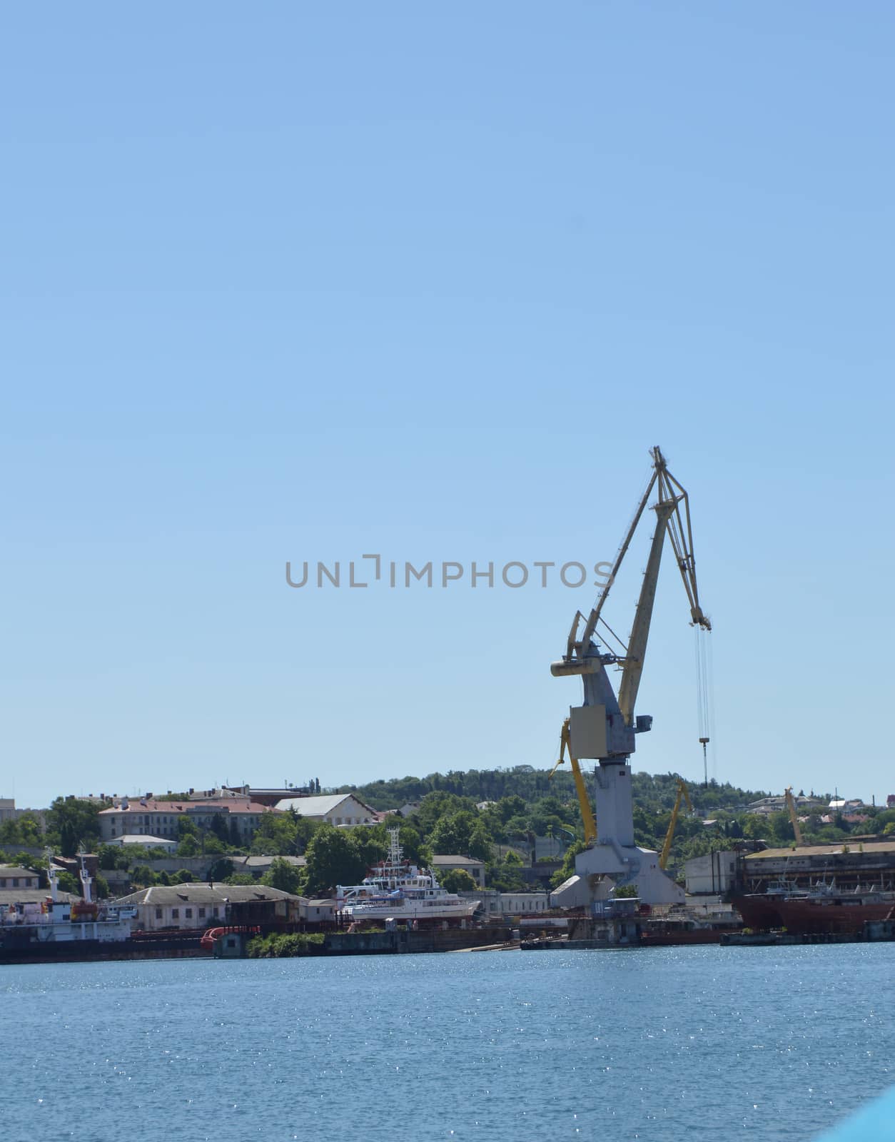 Cranes in cargo port, sea view logistics concept.