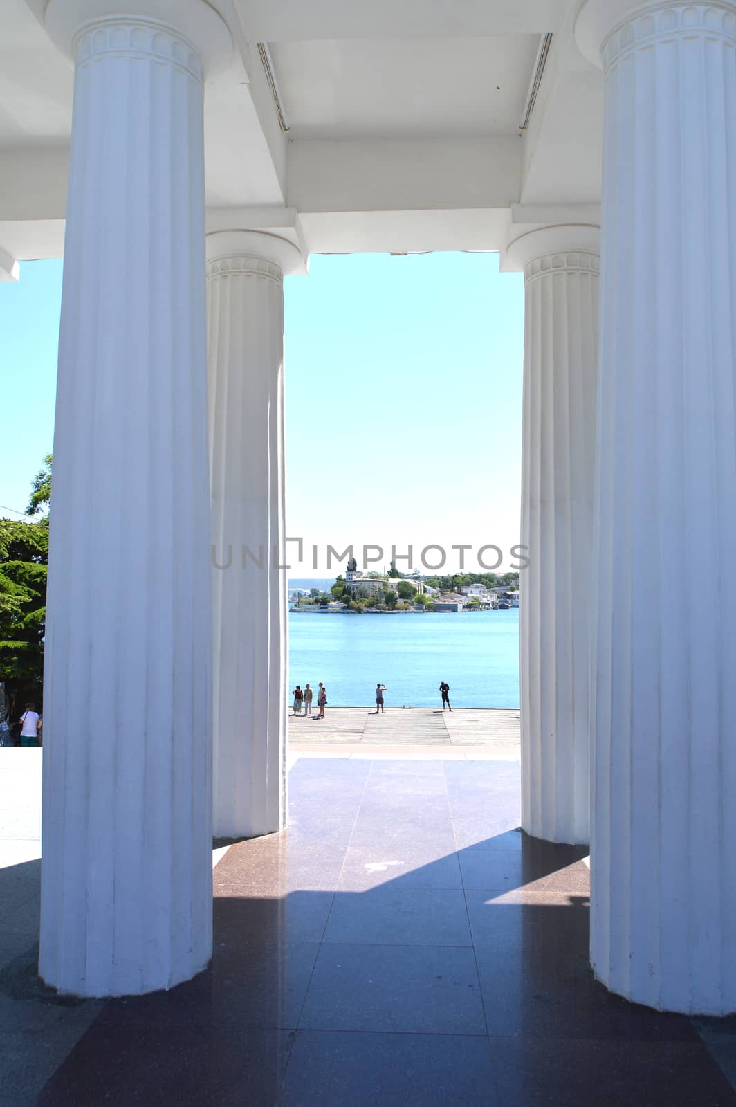 View of the white columns and the sea promenade on a Sunny summer day, resort, tourist attraction.