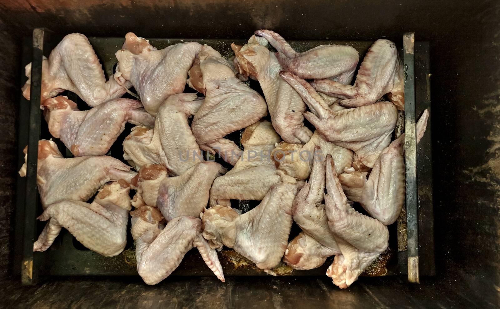 chicken wings prepared for Smoking in the smoker in the country