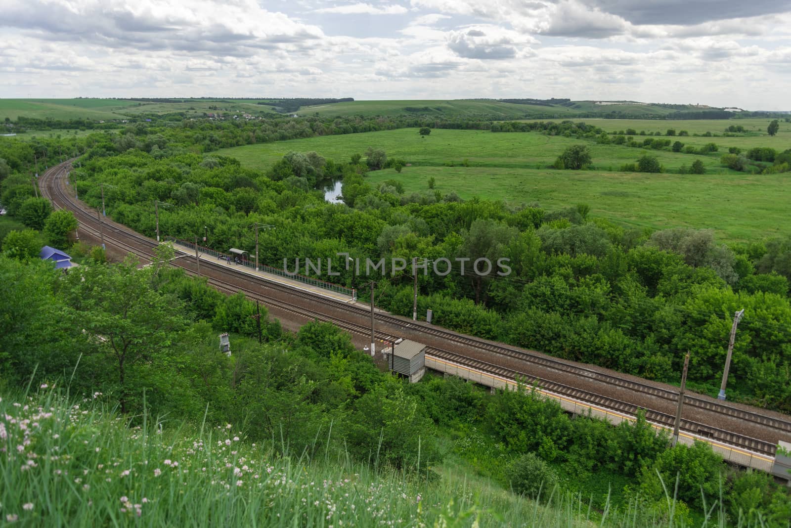 Top view of the railway tracks and a small station in the countryside in Russia by claire_lucia