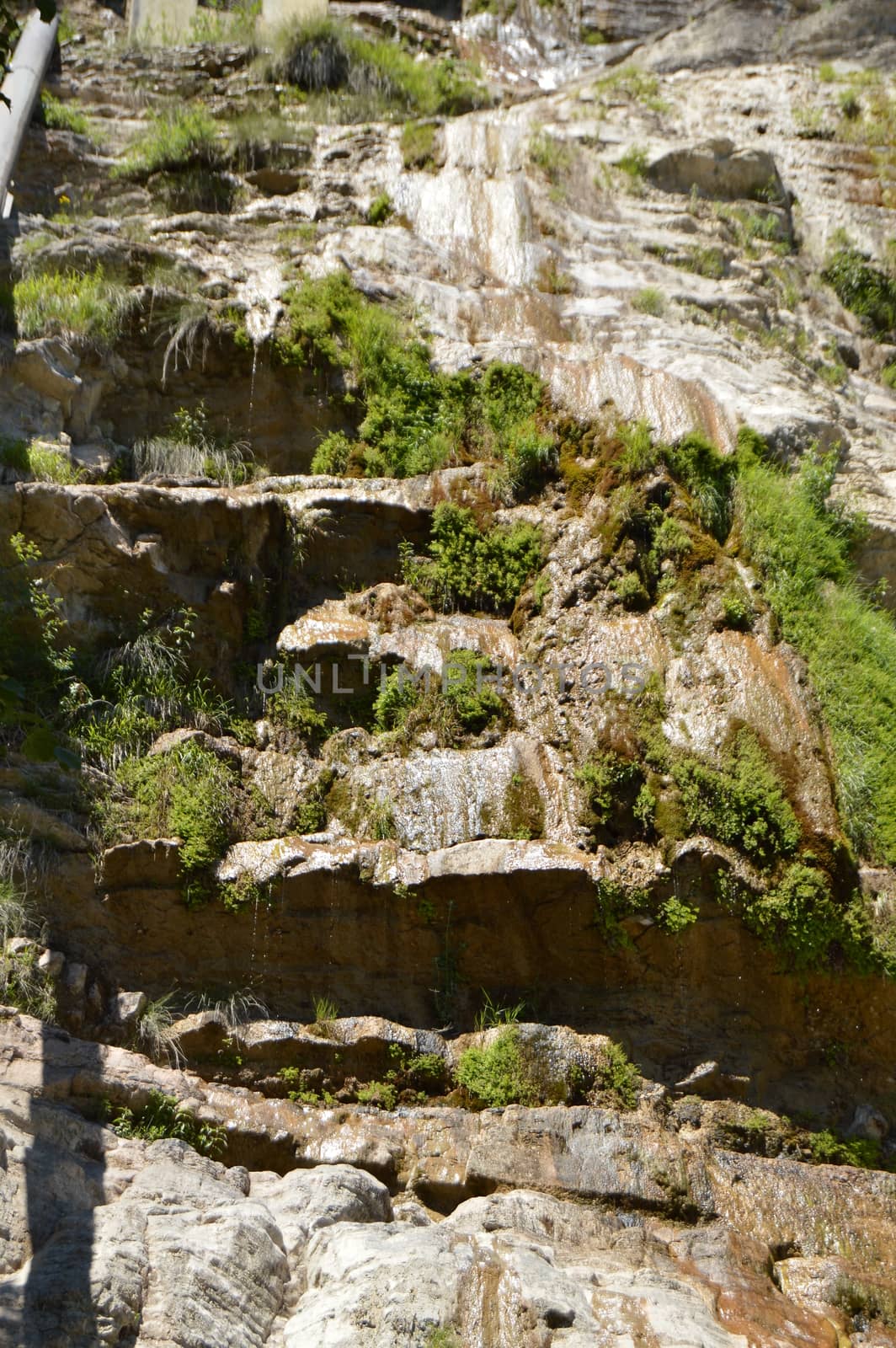 A thin stream of water on the dried waterfall Wuchang-su, Crimea June 2018.
