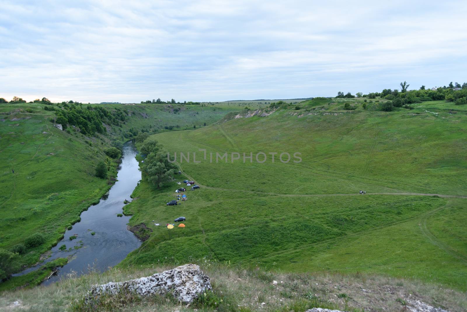 Top view of the camping near a small river with cars and tents, tourism concept by claire_lucia