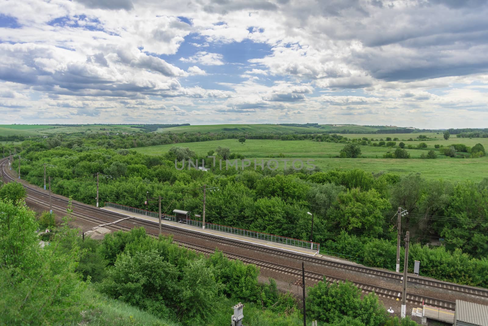 Top view of the railway tracks and a small station in the countryside in Russia.