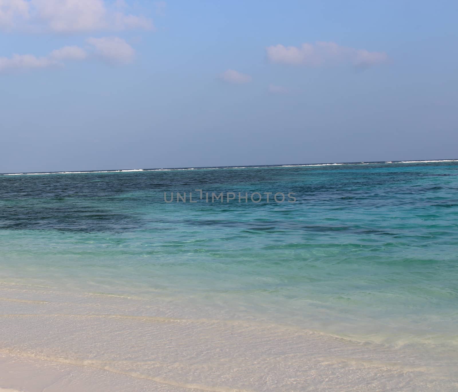 View of Clear Blue Sea Water and White Sands in Maldives Beach. Pictures taken in Day time in Male. Tropical Paradise. Use for Travel, Tourism, Concept.