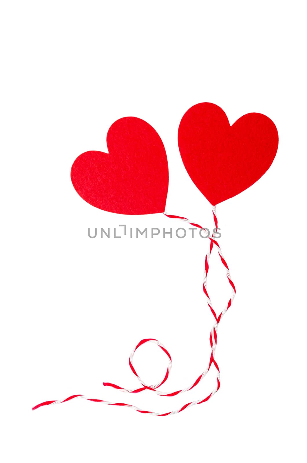 Red heart with rope isolated on white. by Gamjai