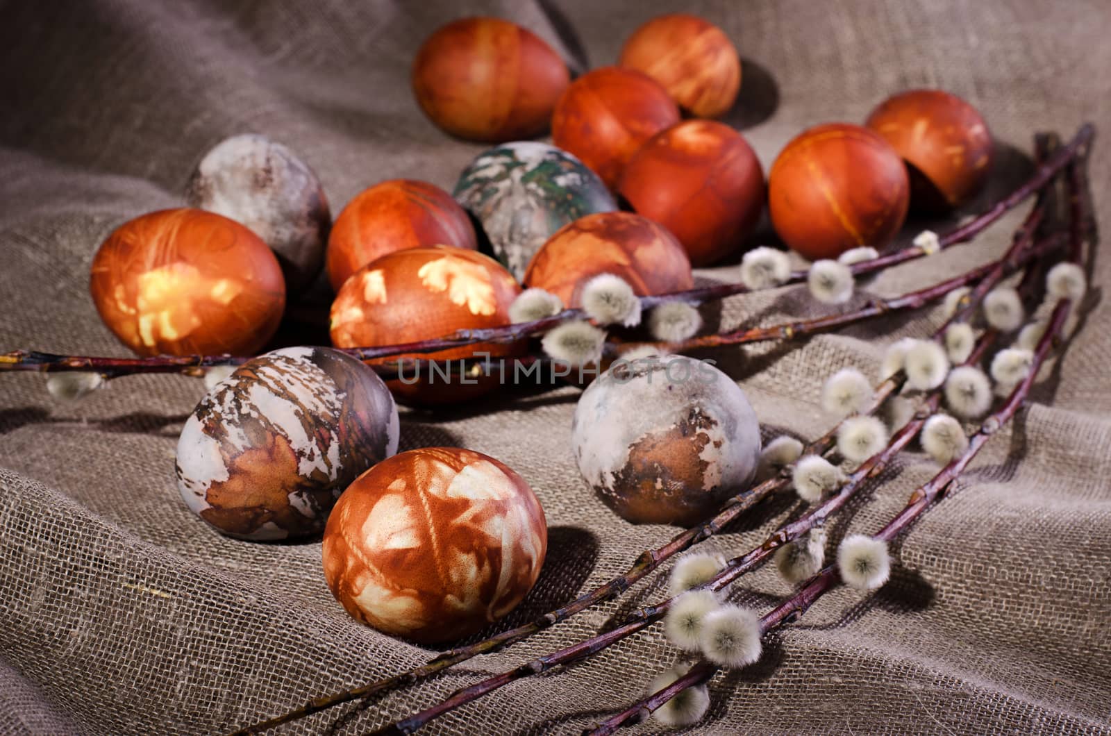 Easter eggs. Painted eggs with pussy willow on the brown linen cloth.