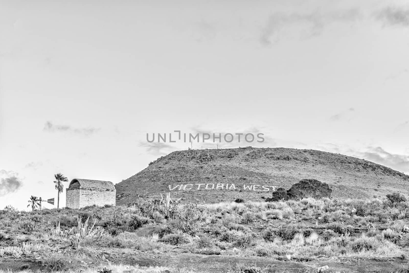 VICTORIA WEST, SOUTH AFRICA, AUGUST 7, 2018: An historic gunpowder magazine in Victoria West in the Northern Cape Province. The name of the town is visible in the back. Monochrome