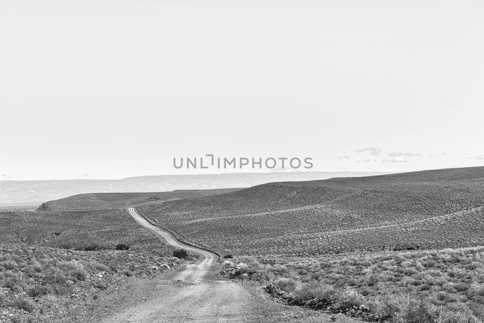 A monochrome landscape on road R356 to Ceres in the Western Cape Province. Snow is visible on Sneeuberg in the Cederberg, to the right