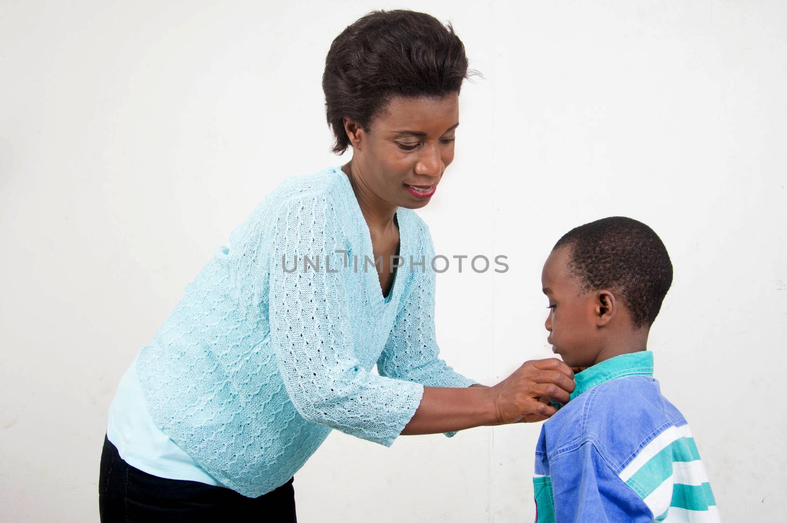 This smiling mother cares for her son.