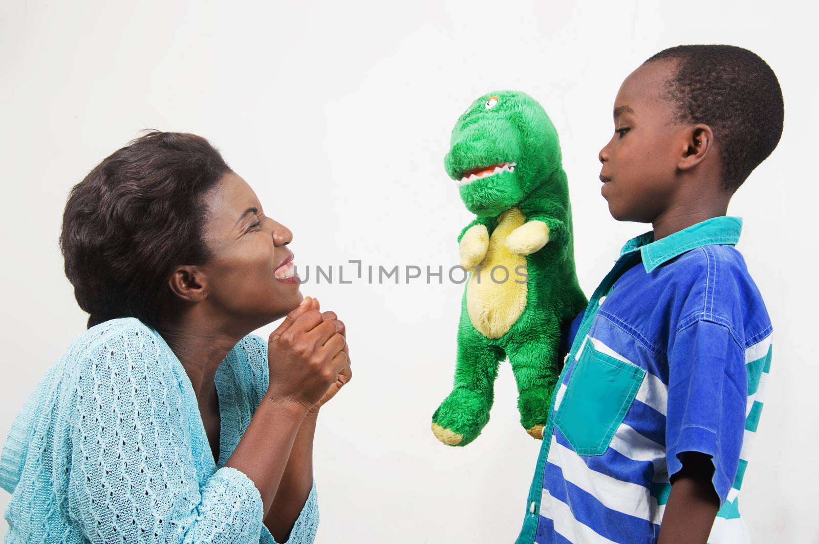 Child playing with his mother holding a toy in hand.