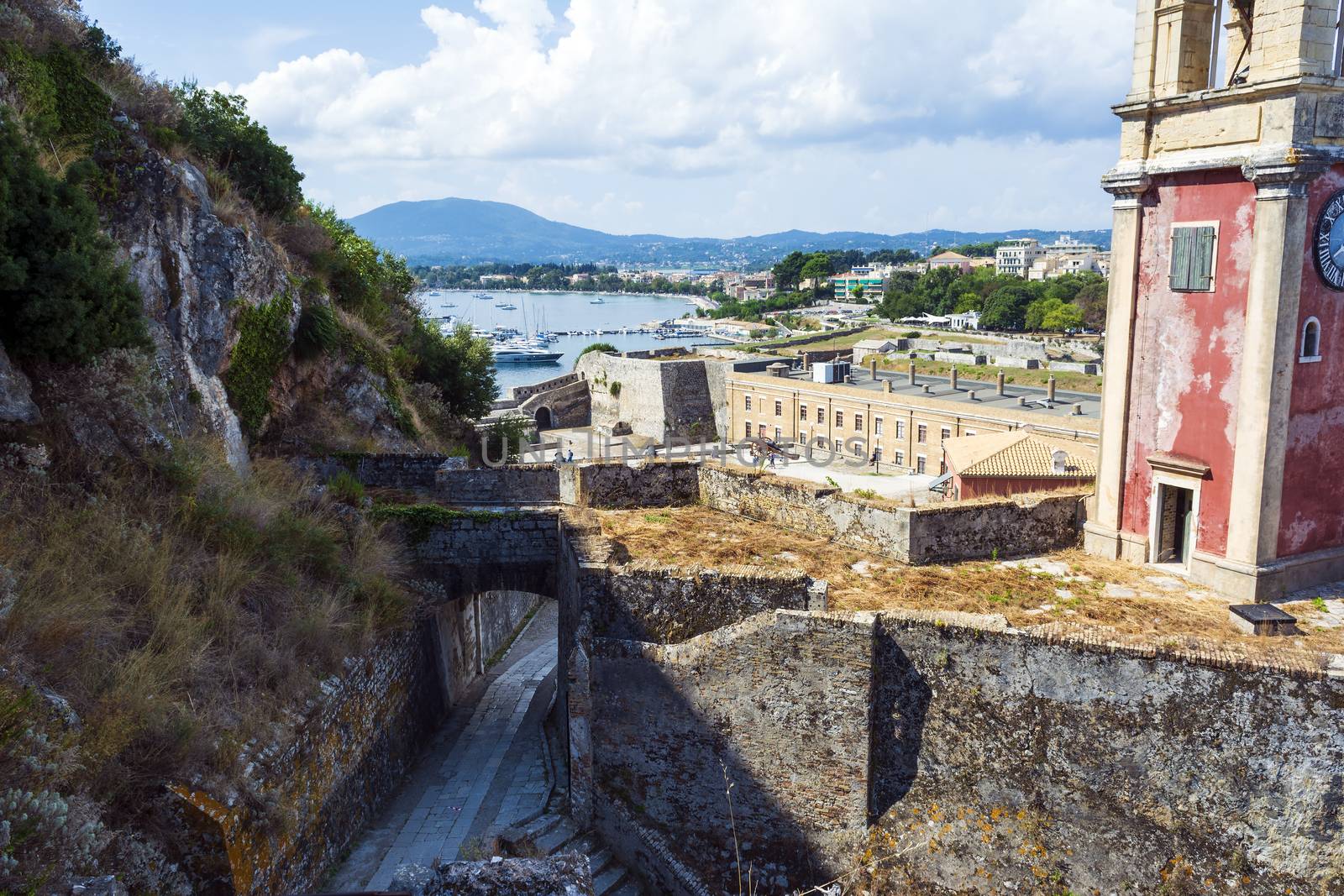 Abandoned clock tower in old fortress in Corfu with panoramic view of Corfu town at Greece.