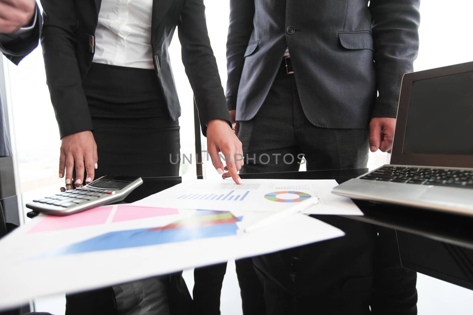 Group of people in business meeting working with documents with diagrams showing successful results