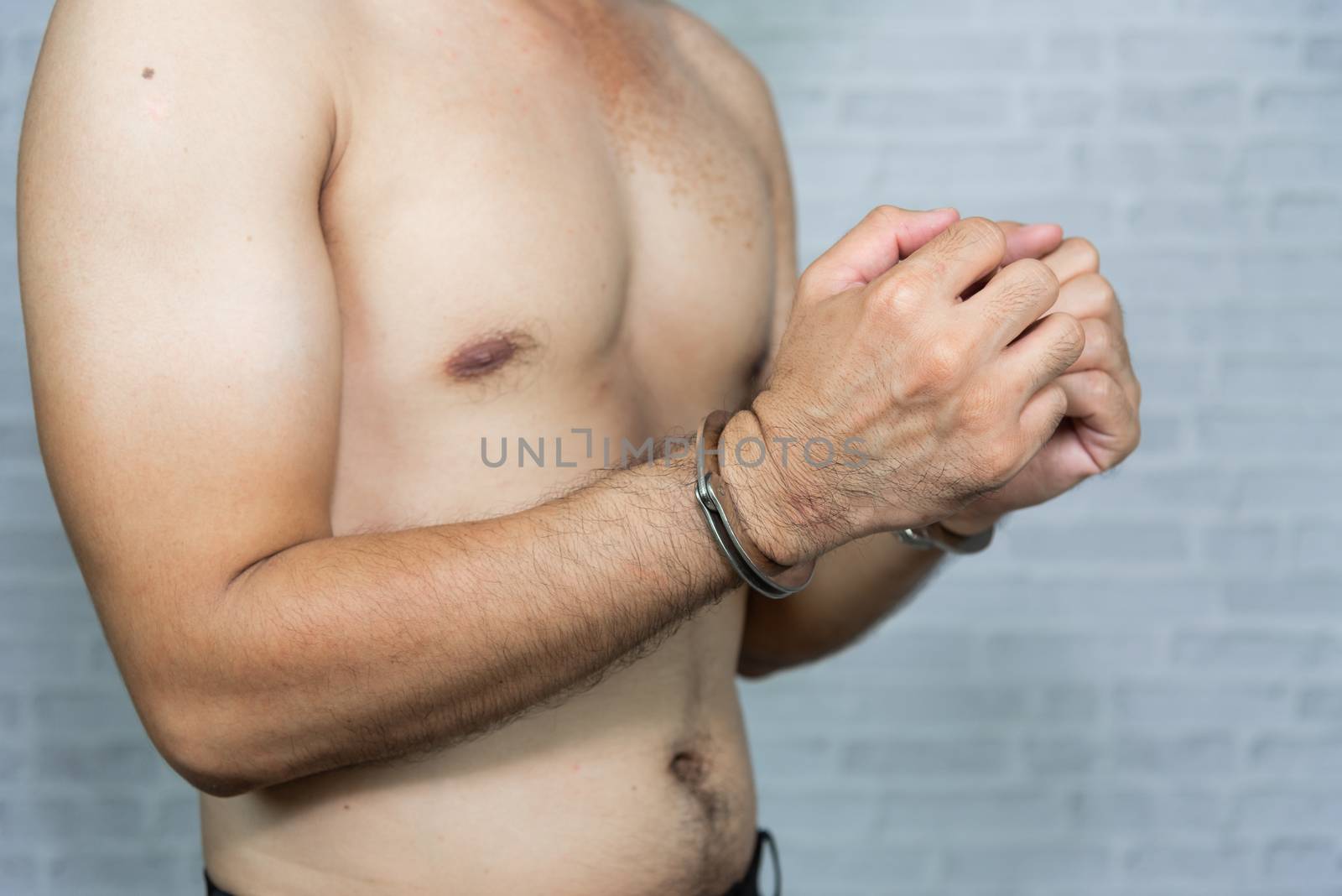 portrait of a man prisoner with handcuff by Wmpix