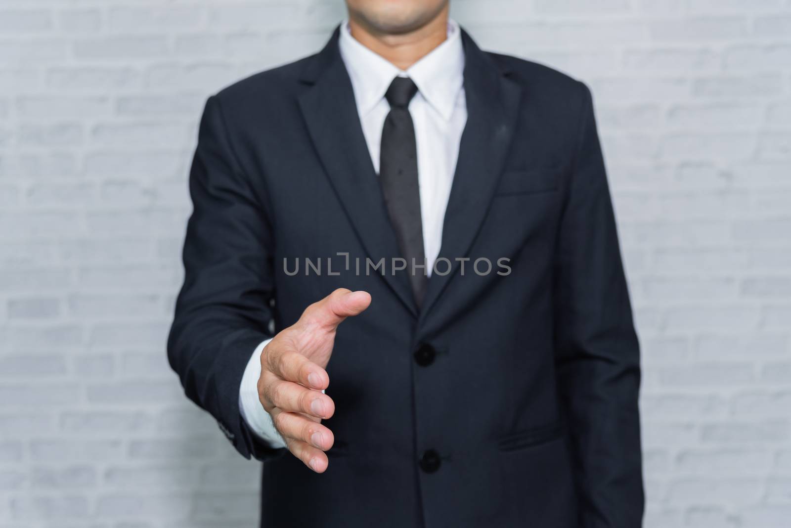 Businessman check hand on gray background by Wmpix