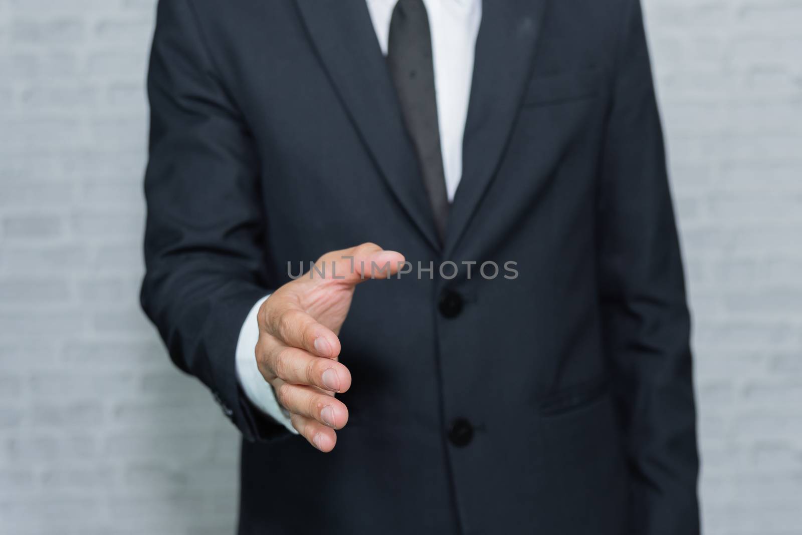 Businessman check hand on gray background by Wmpix