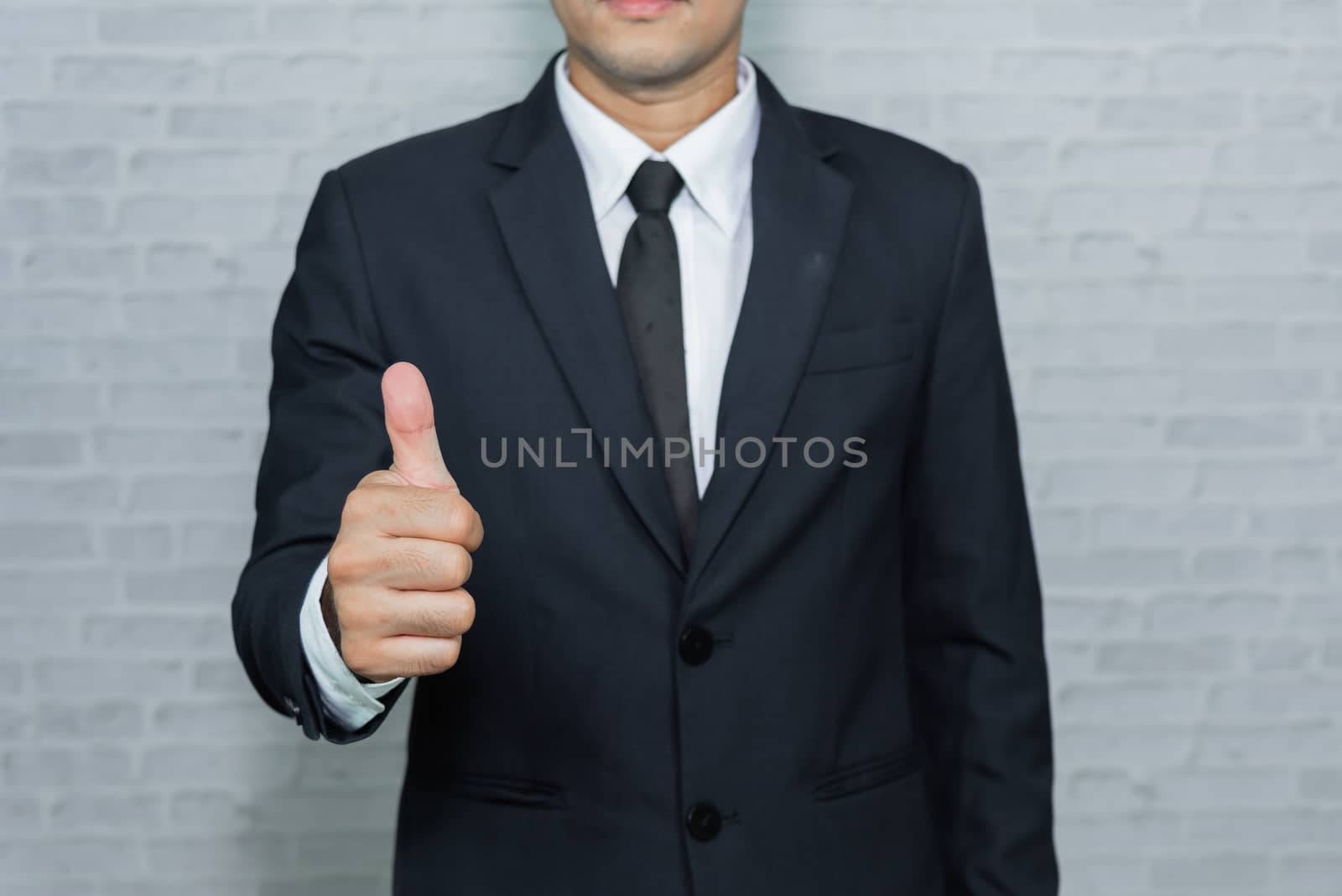 Businessman on gray background by Wmpix
