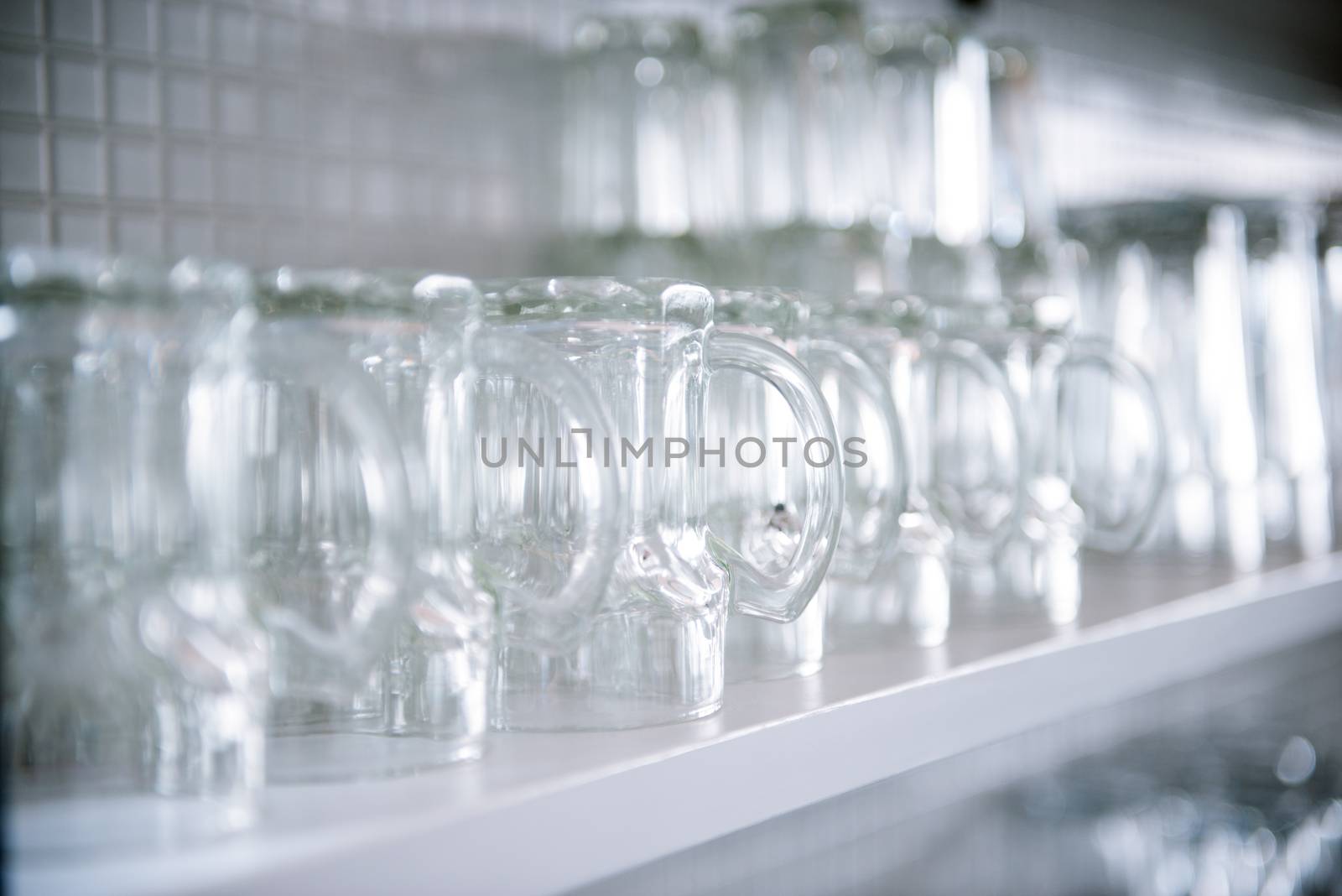 empty beer glasses on the shelf by antpkr