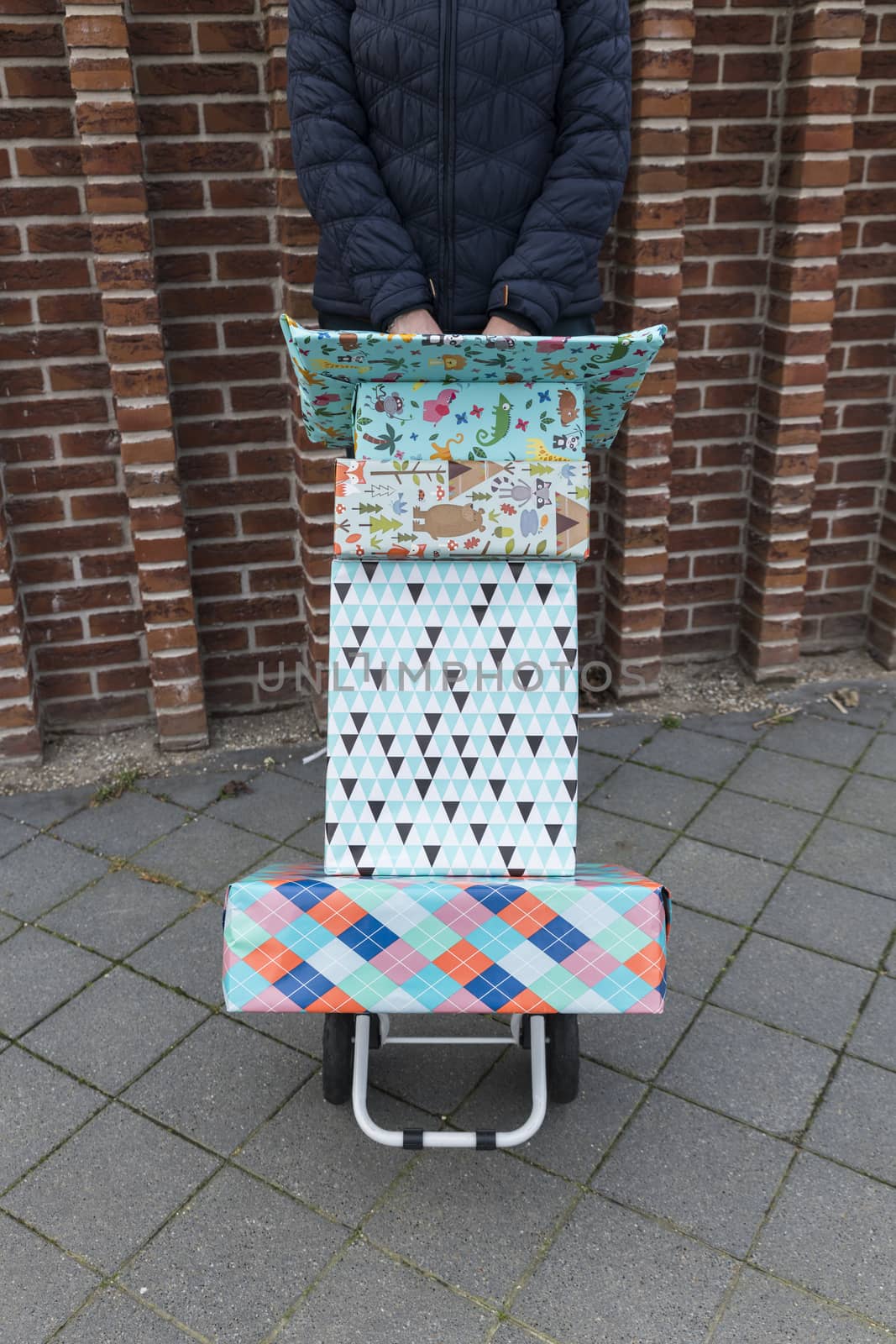 woman with a handtruck full of presents for a birthday party