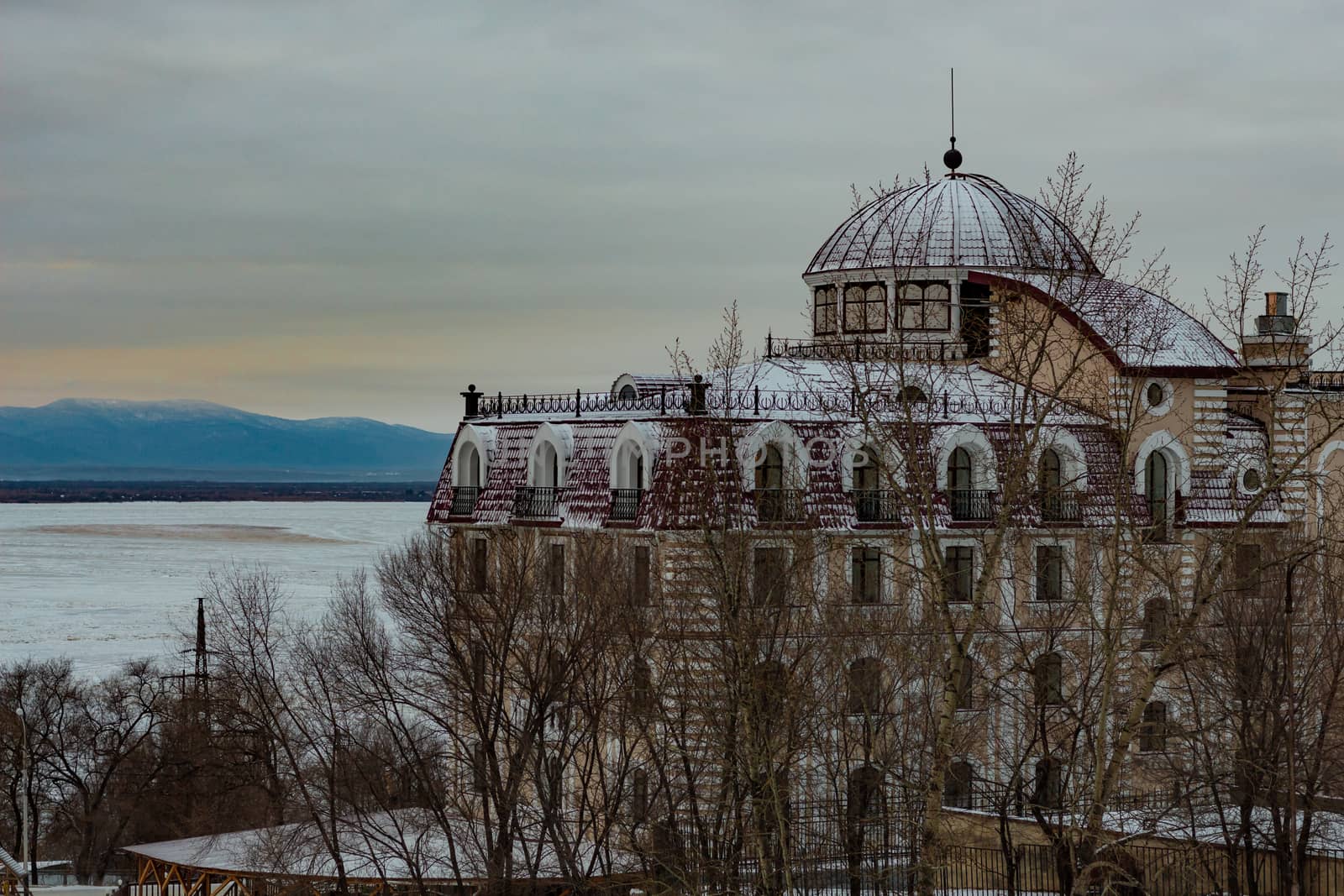 Morning view of the city of Khabarovsk in winter. Urban landscape. Frozen river. Dawn.