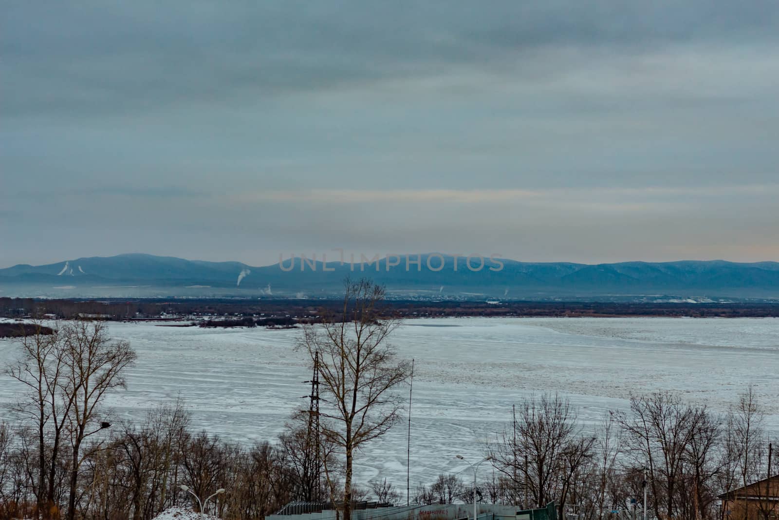 Morning view of the city of Khabarovsk in winter. Urban landscape. Frozen river. Dawn.