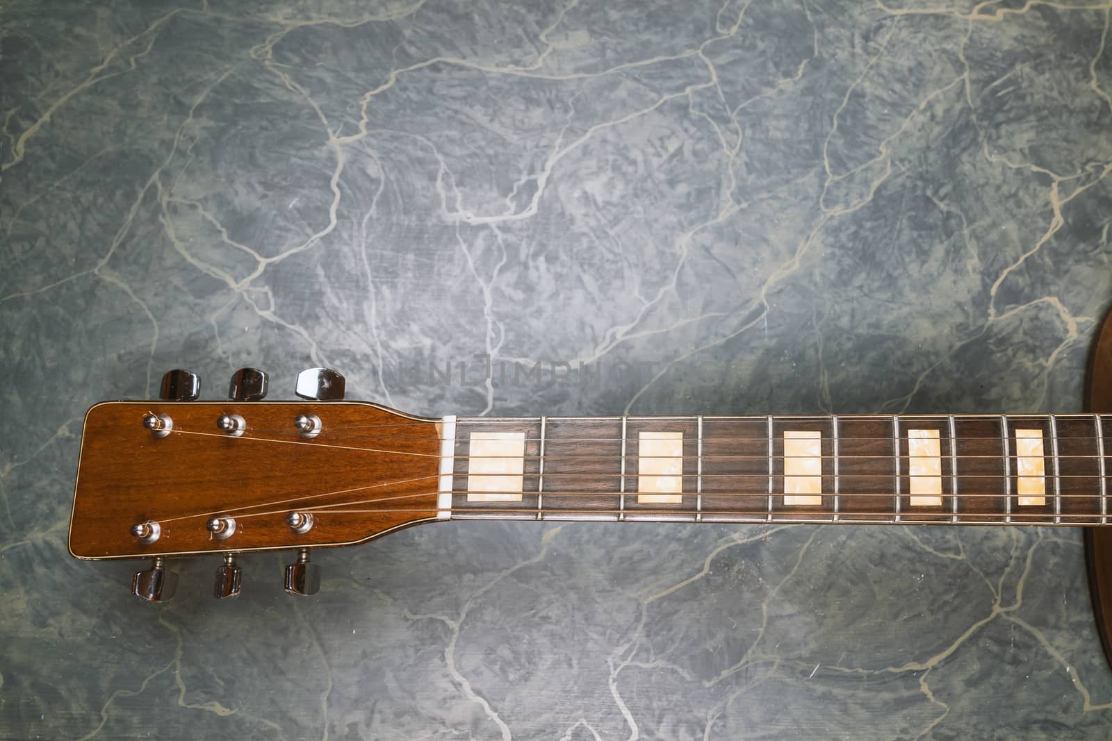 acoustic guitar neck on green marble background,music concept.