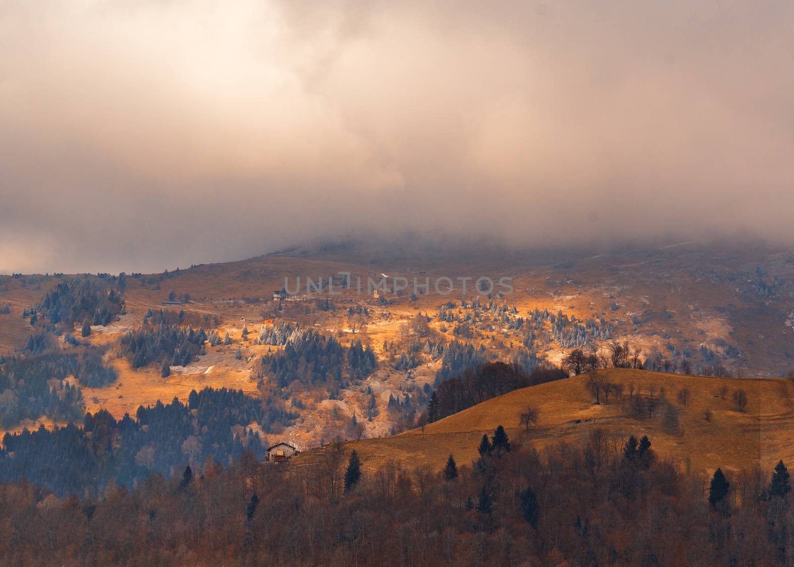 awesome view of the Orobie Alps, autumn / winter, the mountain is a little snow-covered ,the grass is burned by the cold and turns orange.Oltre il Colle,north alps,Seriana Valley,Bergamo Italy.