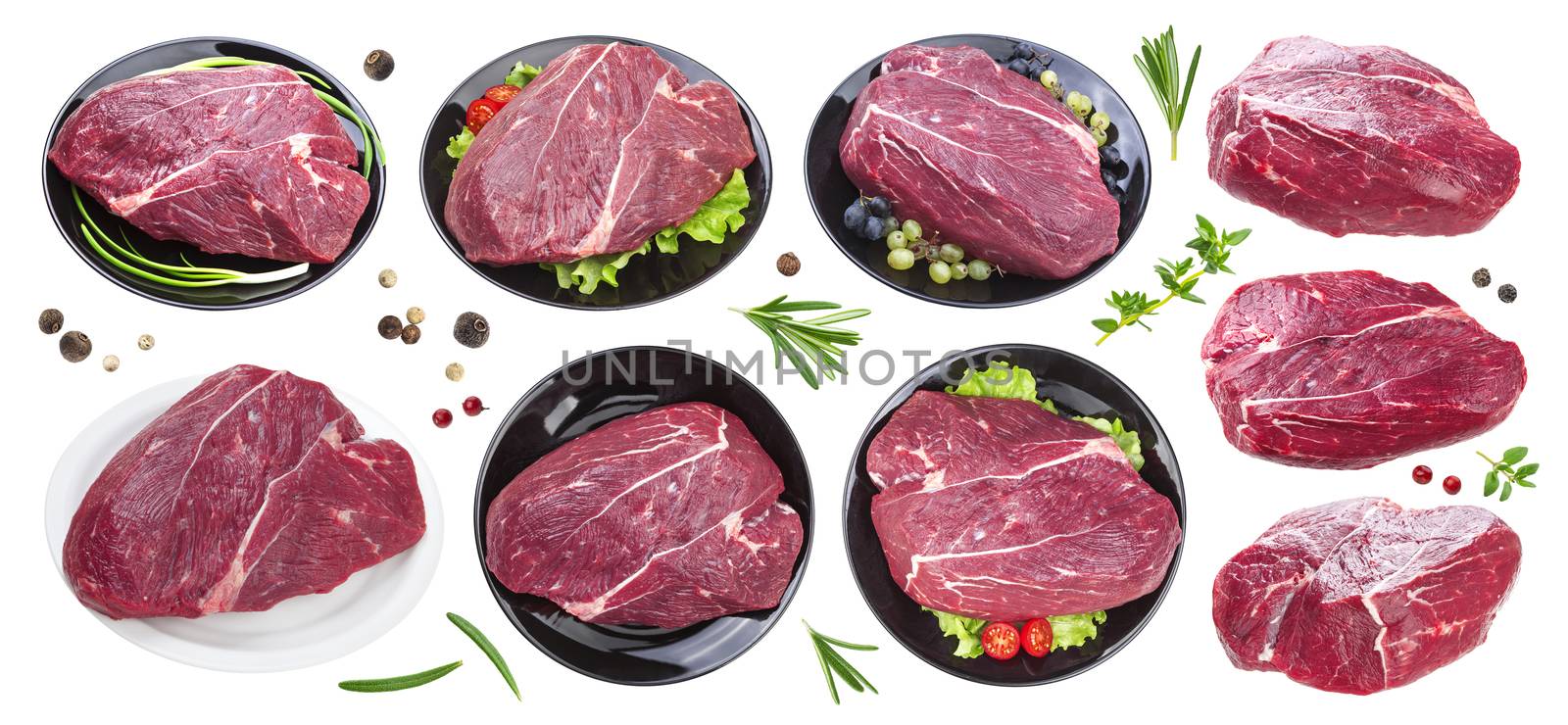 Piece of raw beef on black plate isolated on white background with clipping path, collection, with spices and herbs