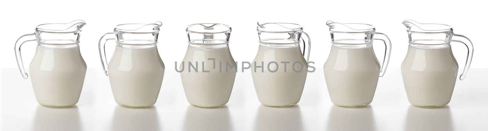 Glass jug of milk isolated on white background, cream or milk pitcher, collection