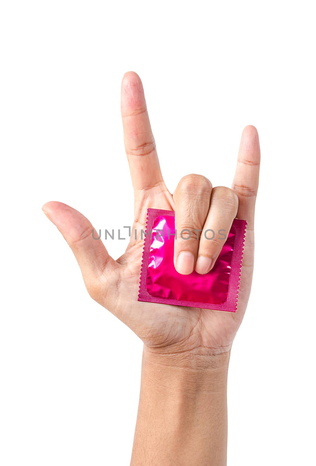 Pink condom in pack on hand showing love symbol. by Gamjai