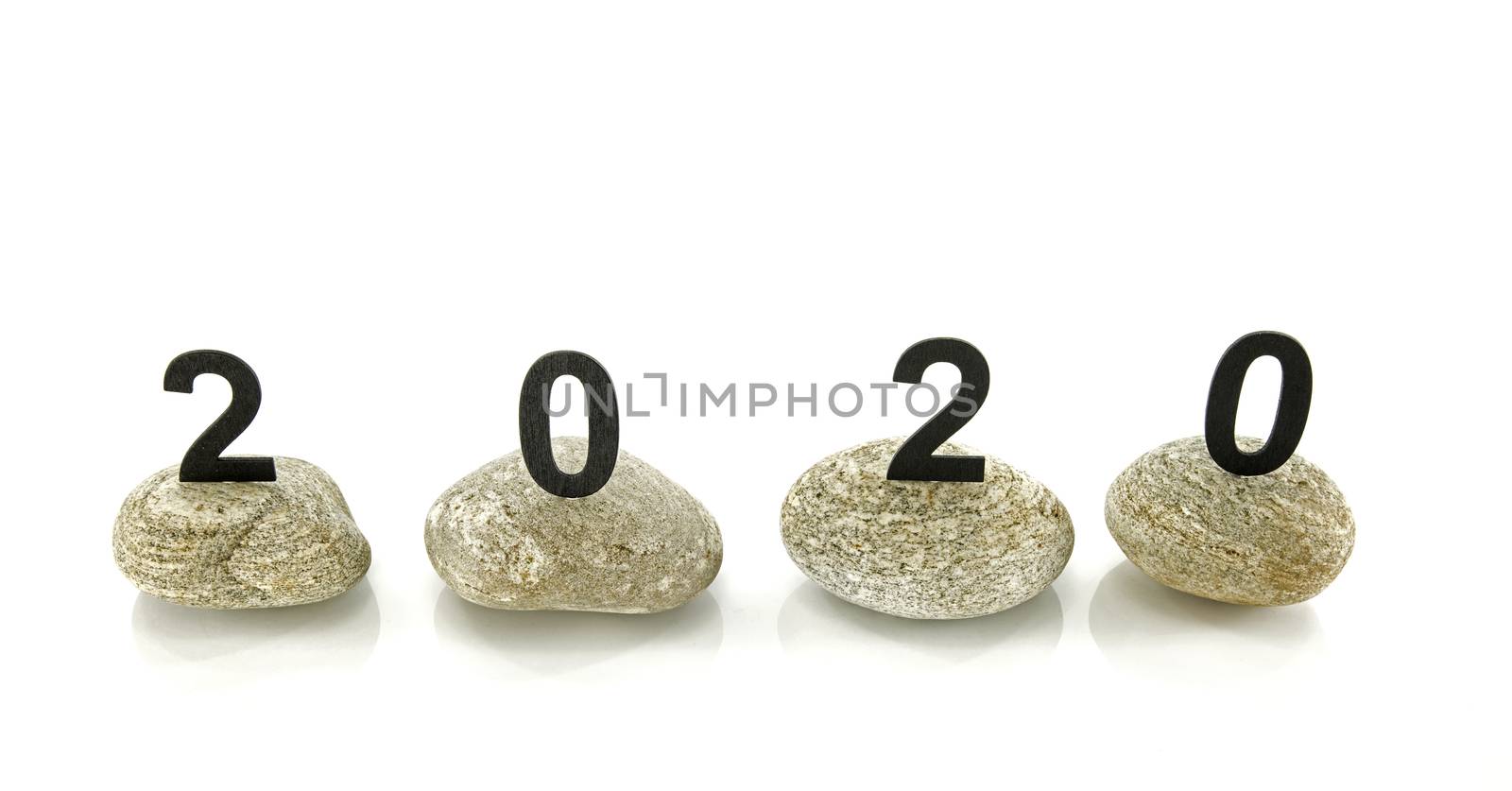 New years resolution 2020 concept, Wooden year number on stones isolated on white background with reflection and copy space