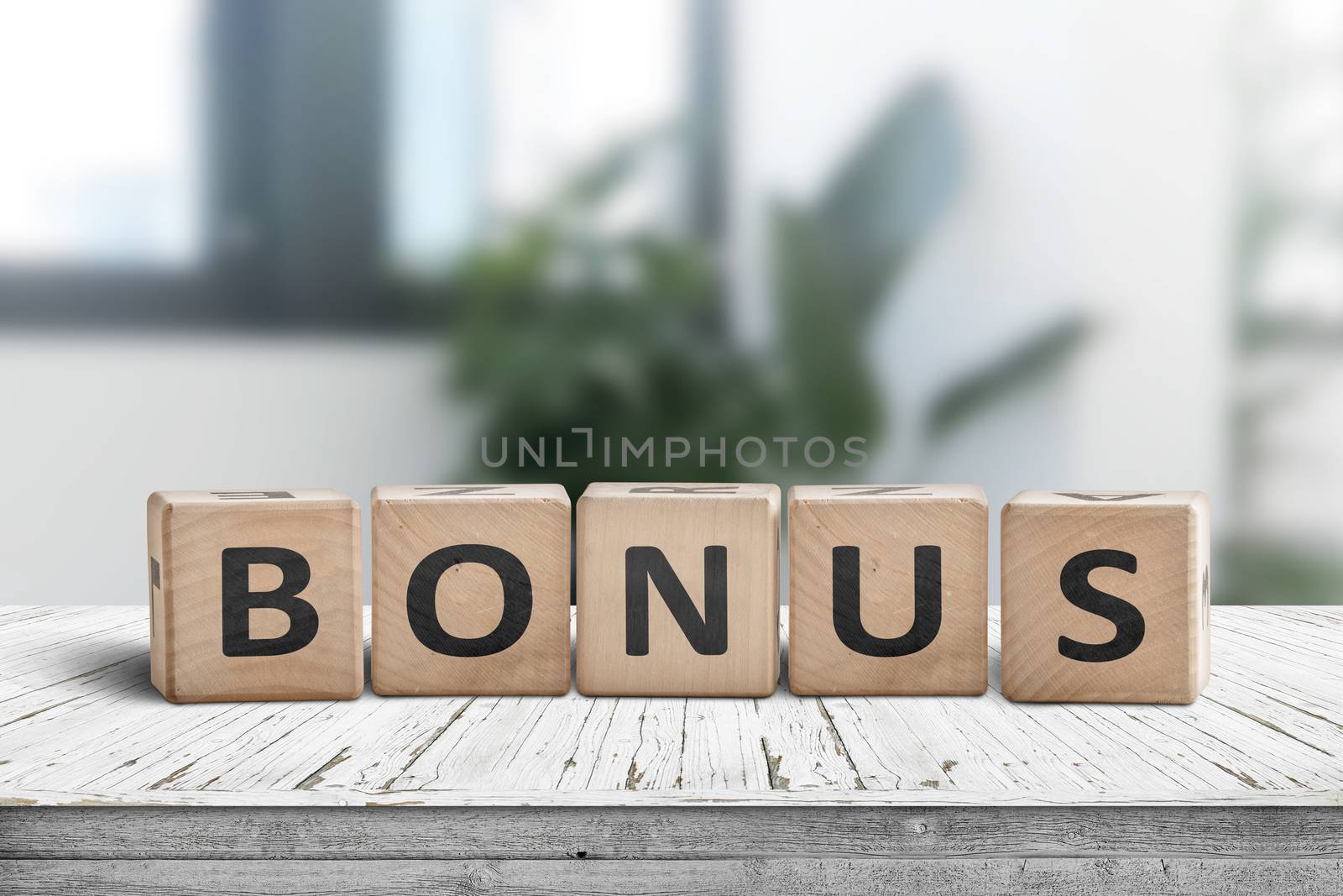 Bonus reward sign on a white table in a bright office with green plants