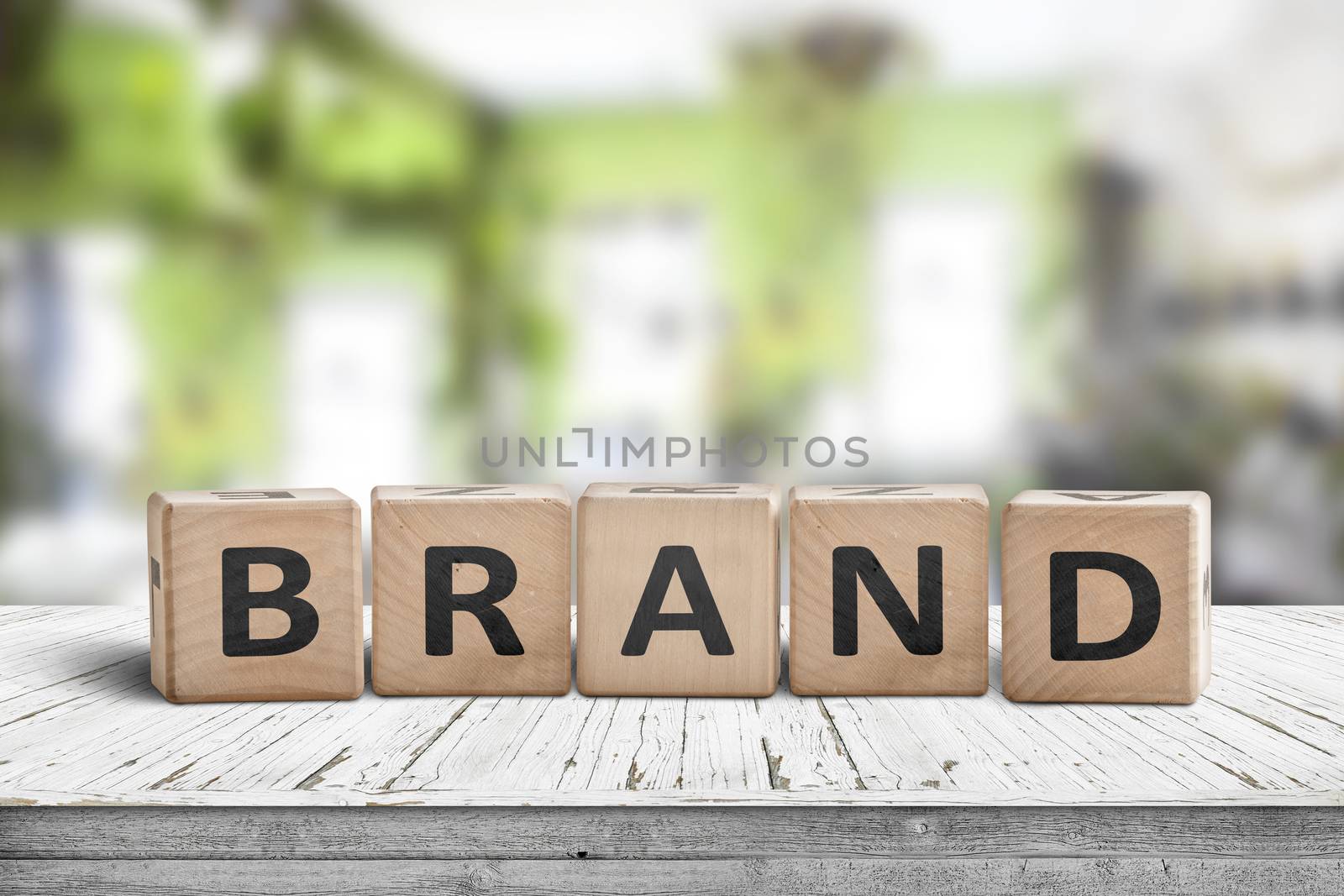 Brand sign spelled with wooden cubes on a table in a bright green room