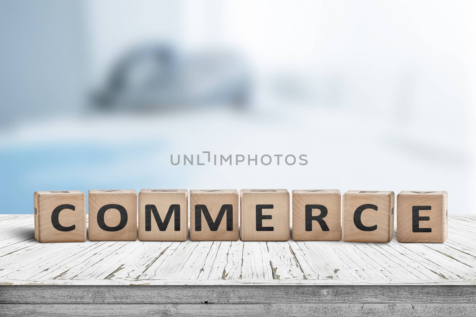 Commerce word on a wooden cube sign with a blurry blue background on a desk