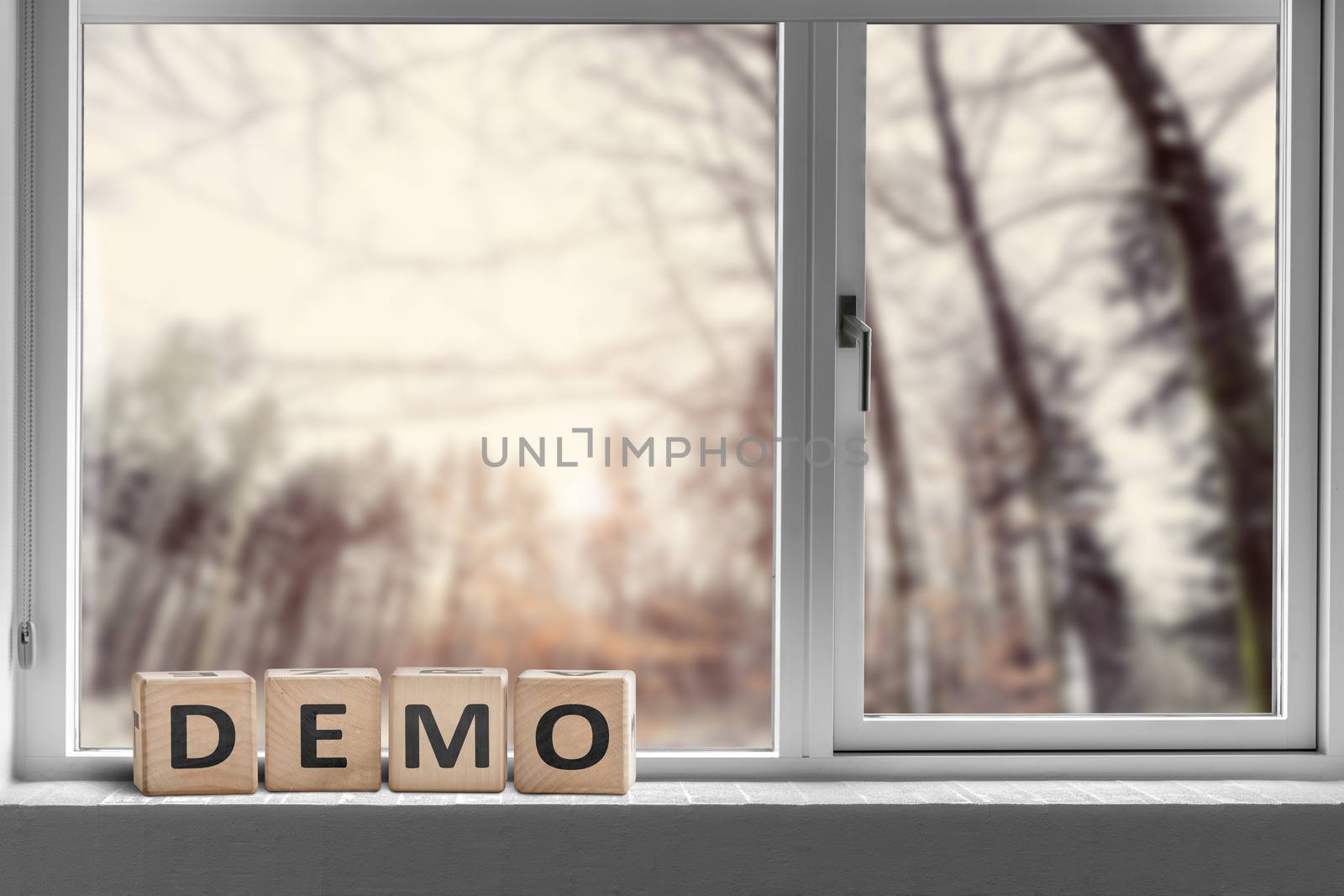 Demo sign in a window with a view to a forest in the morning
