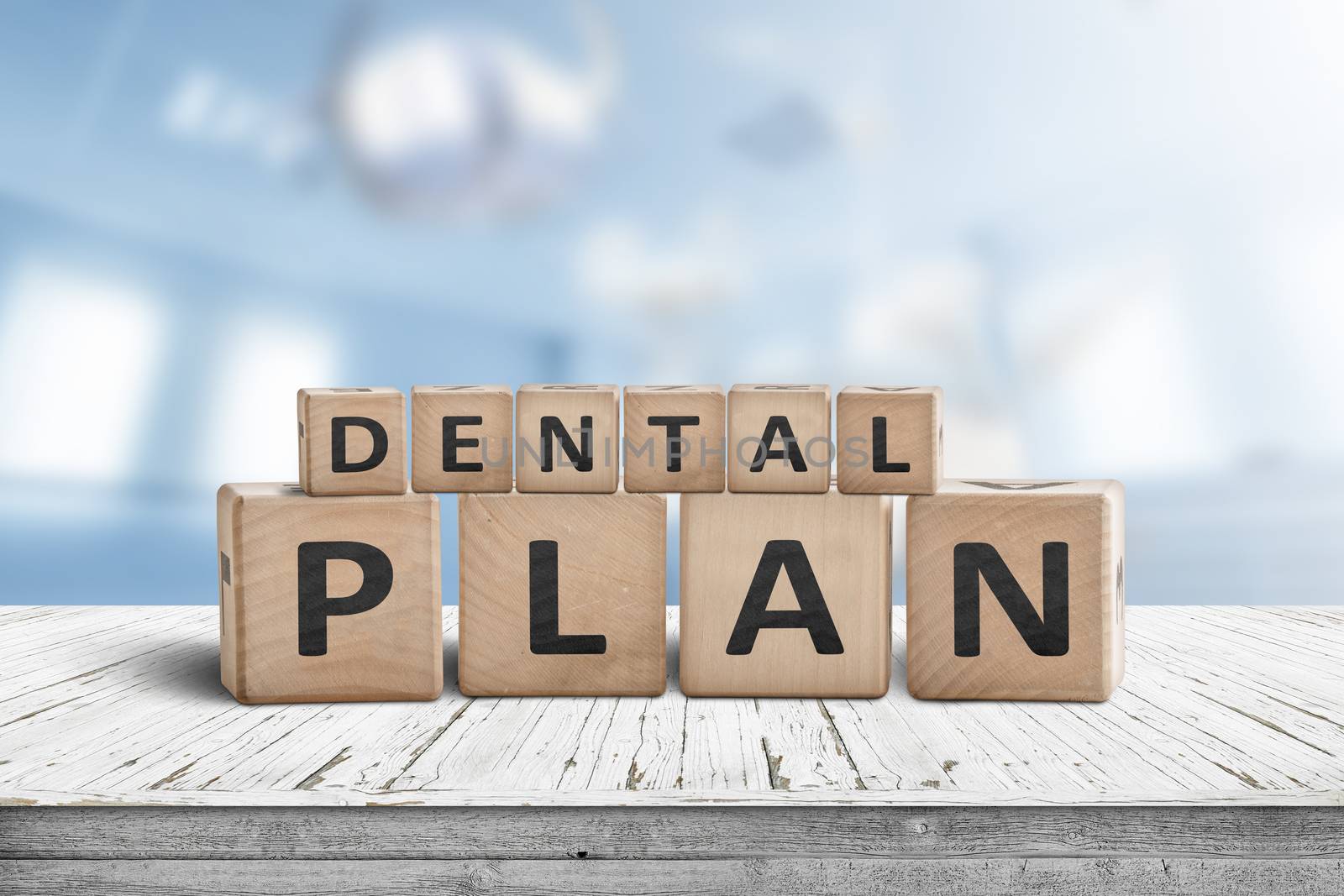 Dental plan sign with a blue room in the background with dentist equipment