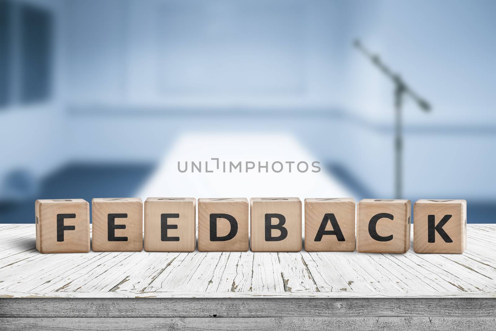 Feedback word on wooden cubics in a blue room by Sportactive