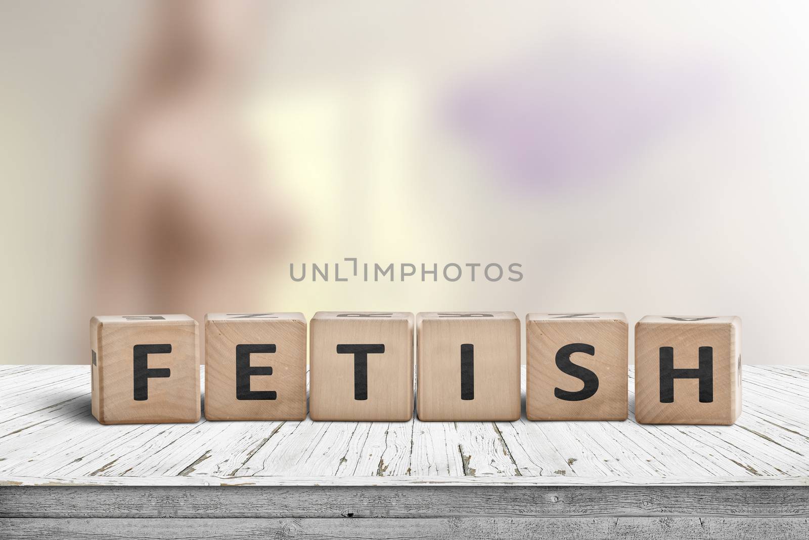 Fetish word on wooden cubes on a table with a blurry background